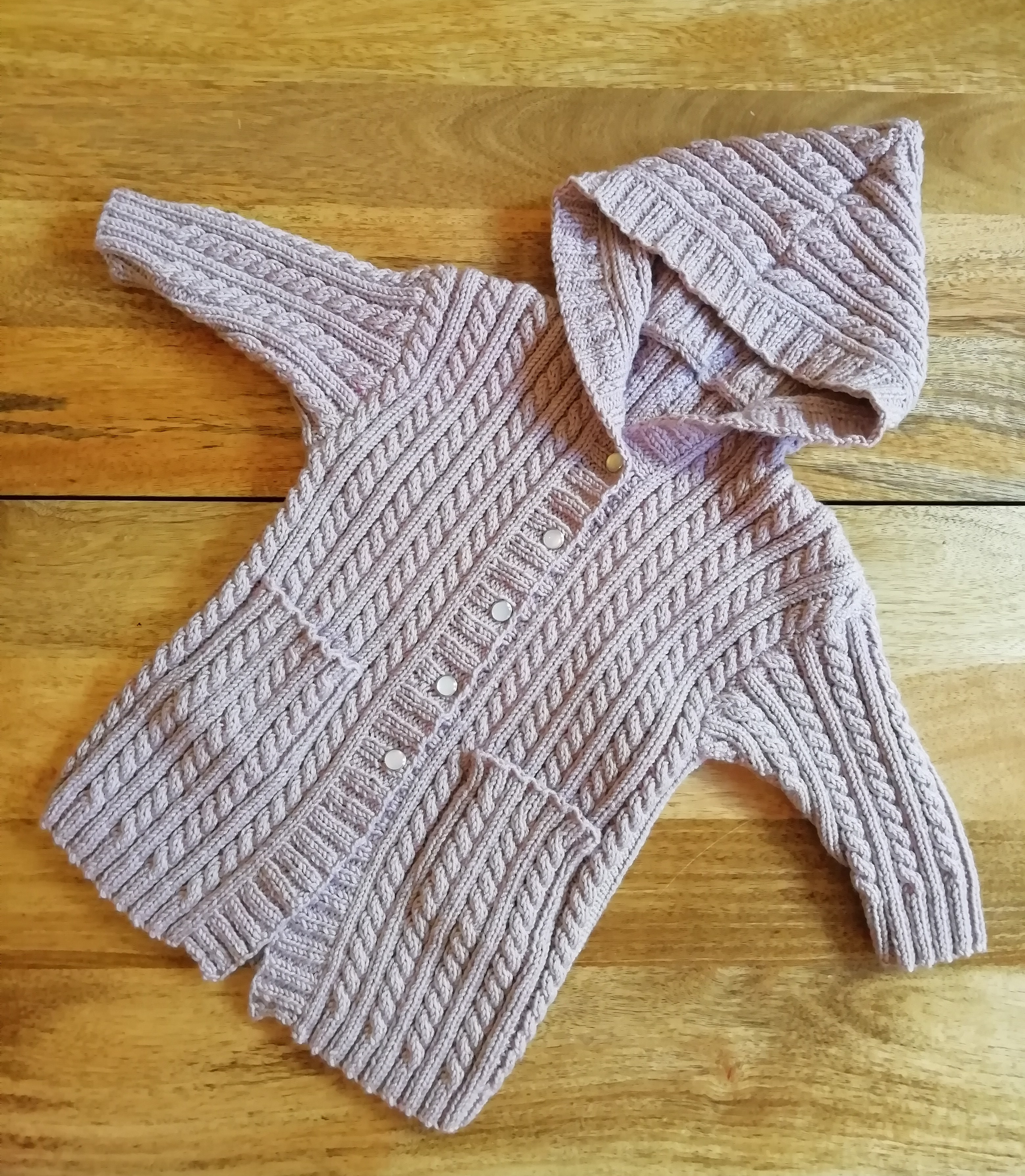 Baby Hooded Cardigan, a cabled pattern where I used poppers instead of buttons
